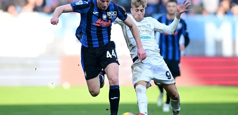 Cagliari player challenges Atalanta opponent for ball