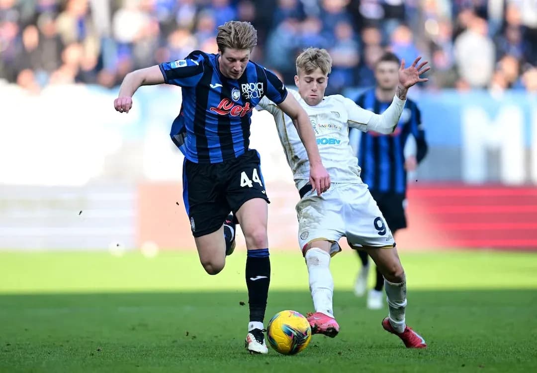 Cagliari player challenges Atalanta opponent for ball