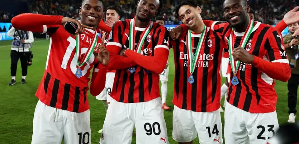AC Milan players celebrating with medals after match