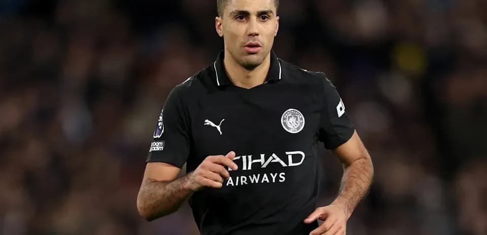 Player running on field in Manchester City kit