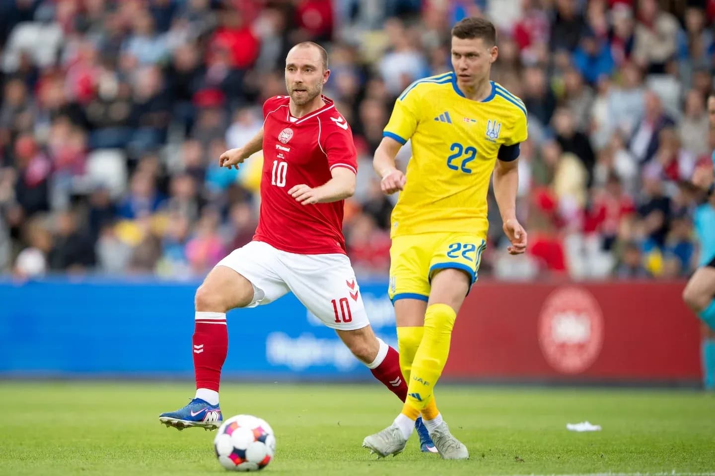 Denmark and Ukraine players competing for the ball Denmark and Ukraine players competing for the ball