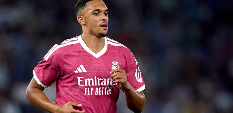 Player running in pink Real Madrid jersey during match