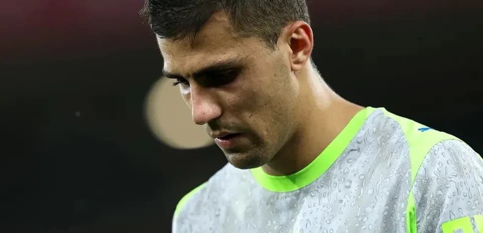 Player looking down in training gear with raindrops