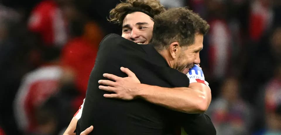 Two players embracing after a match victory
