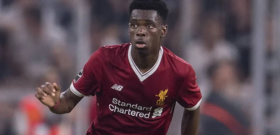 Player in red Liverpool kit running on field