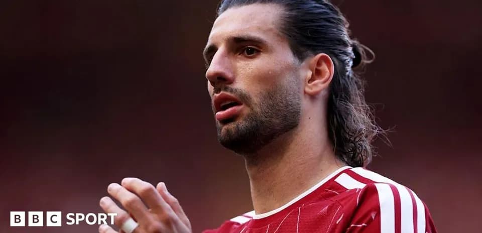 Player in red jersey preparing for match