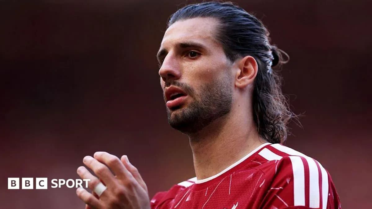 Player in red jersey preparing for match