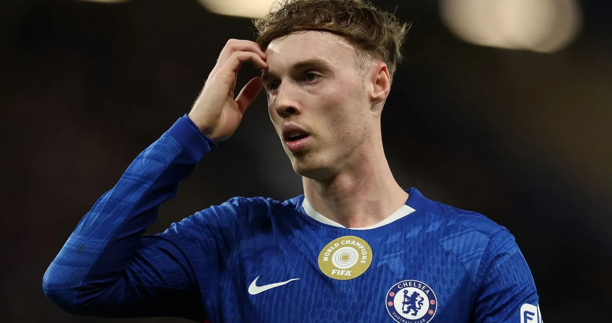 Player in Chelsea jersey looking pensive on field