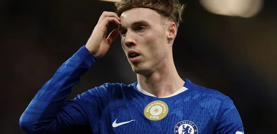 Player in Chelsea jersey looking pensive on field