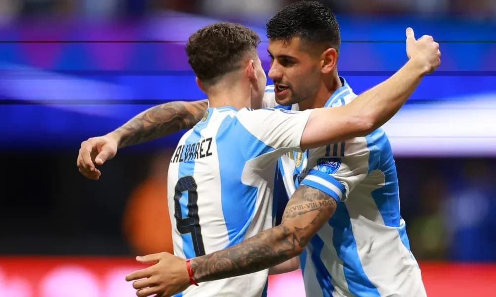 Two Argentine players celebrating a goal together