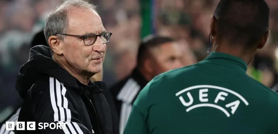Coach interacting with UEFA official on sidelines
