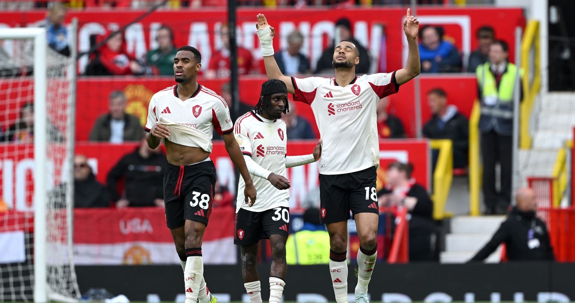 Three players celebrating after scoring a goal