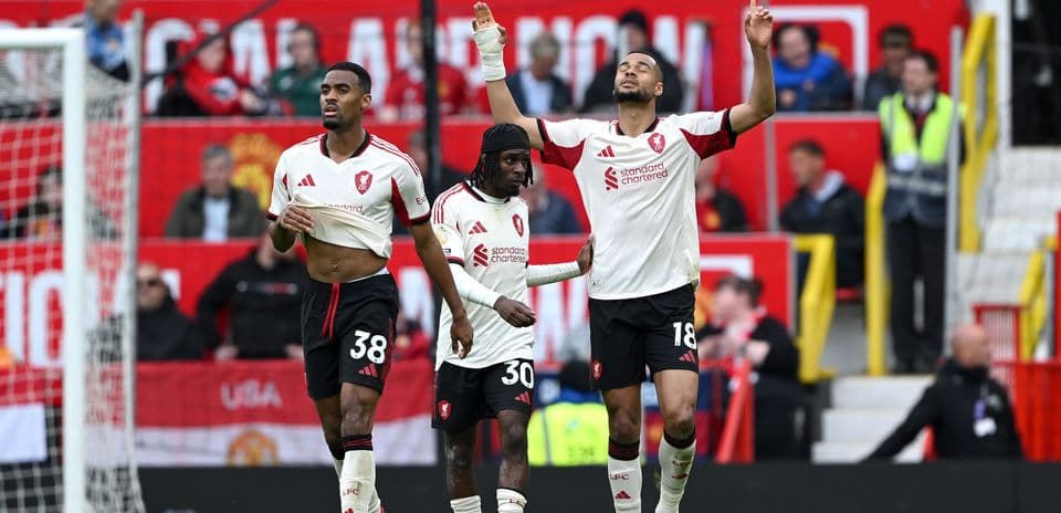Three players celebrating after scoring a goal