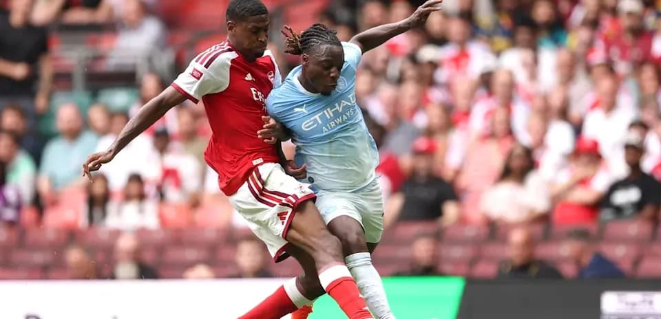 Player tackling opponent during football match