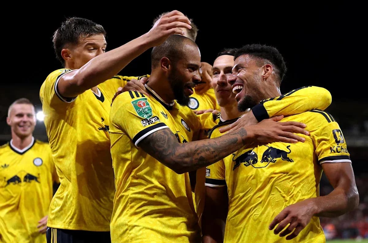Players celebrating a goal in yellow jerseys