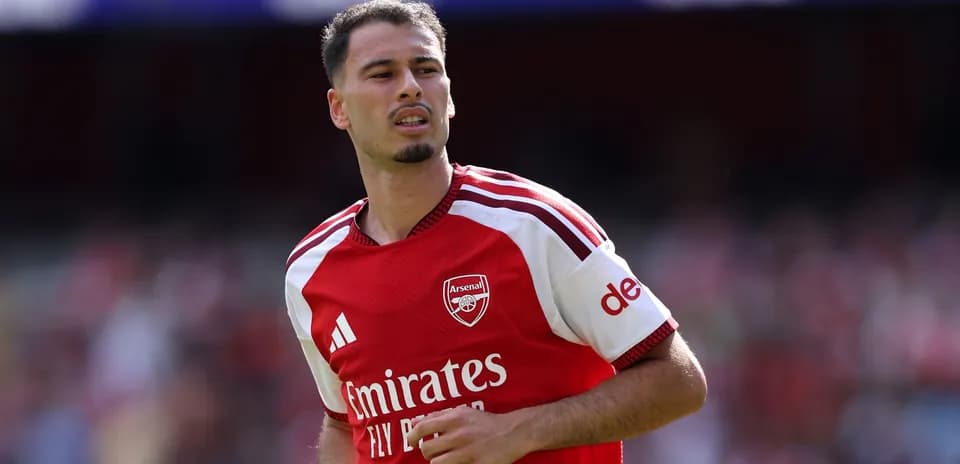 Player in Arsenal jersey during match warm-up
