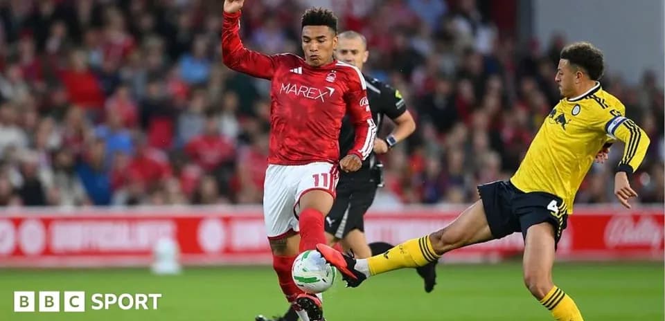 Player in red jersey avoiding a tackle during match