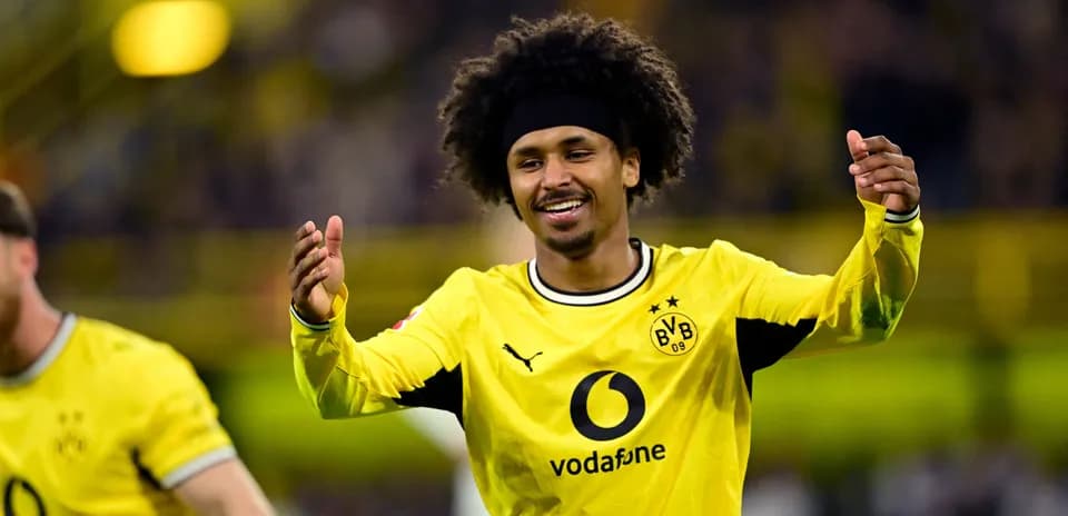 Player celebrating a goal in Borussia Dortmund jersey