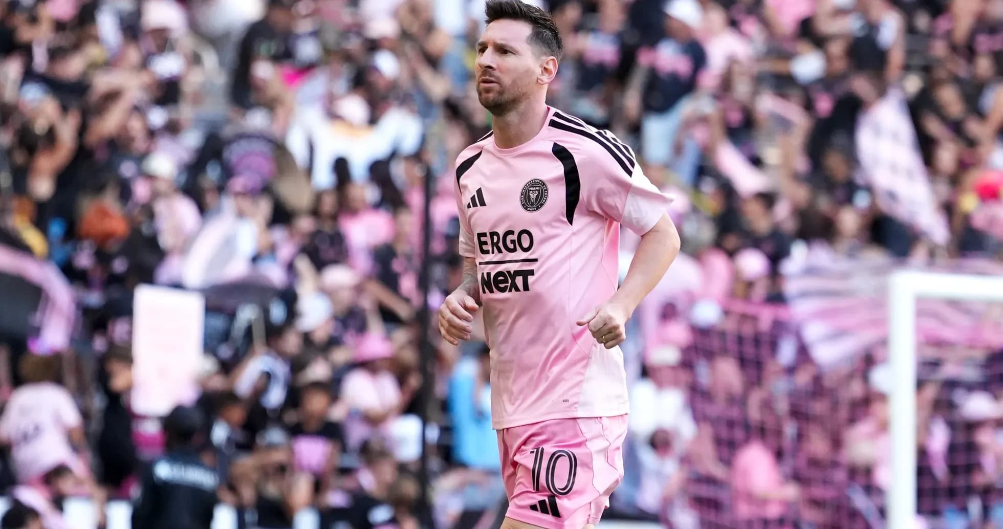 Lionel Messi running on field in pink uniform