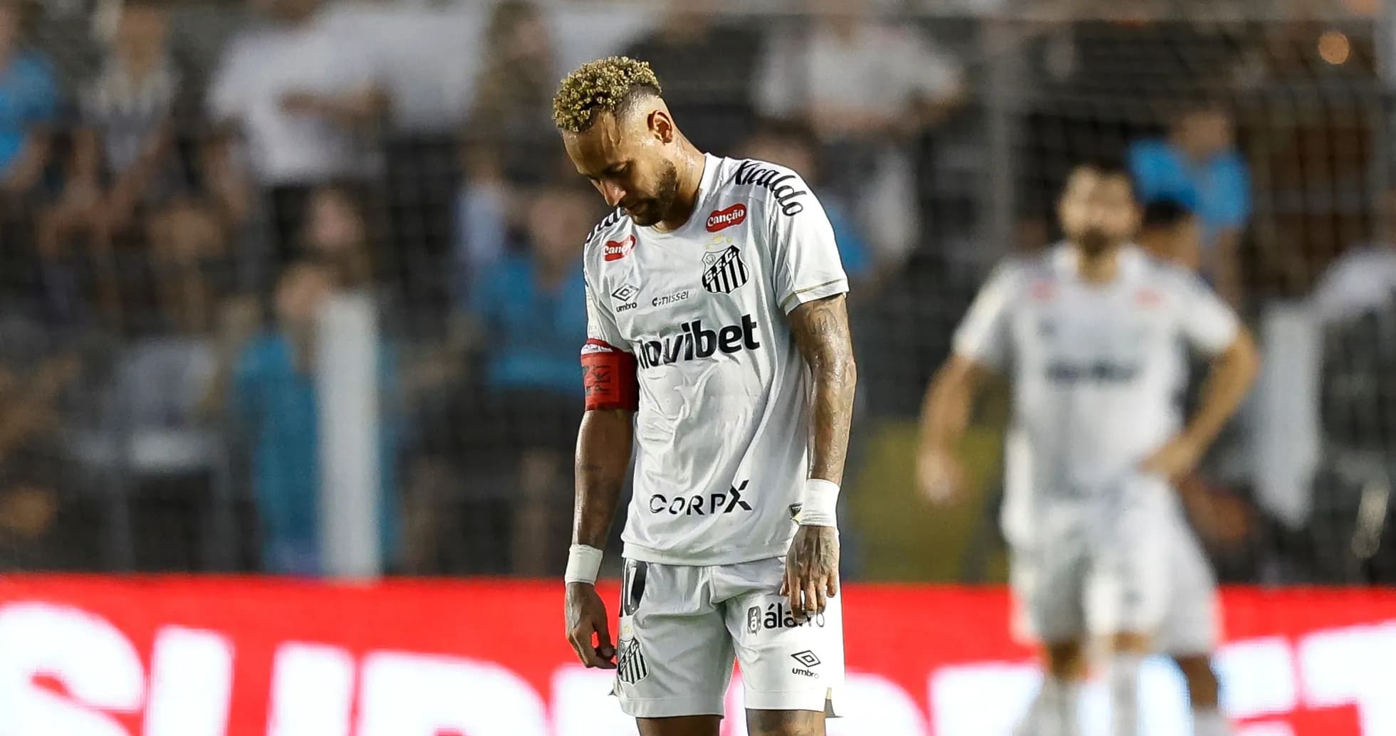 Player in Santos jersey looking down during match