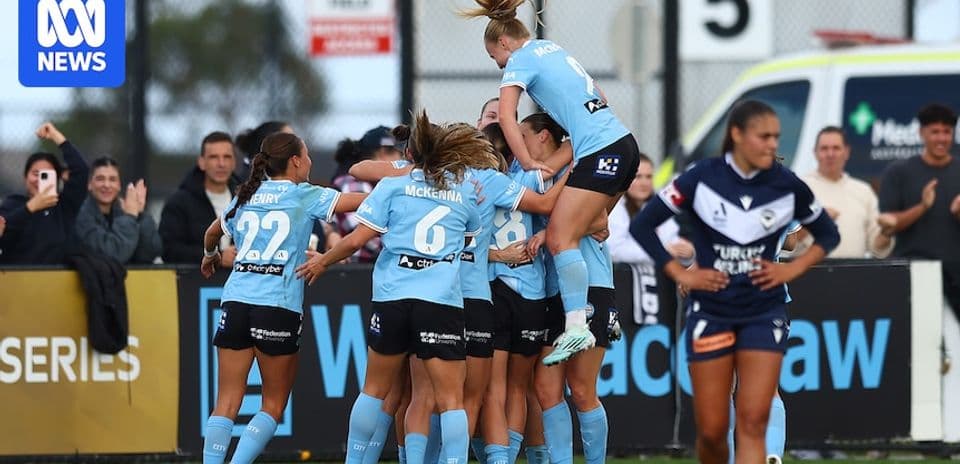 Players celebrating a goal on the field