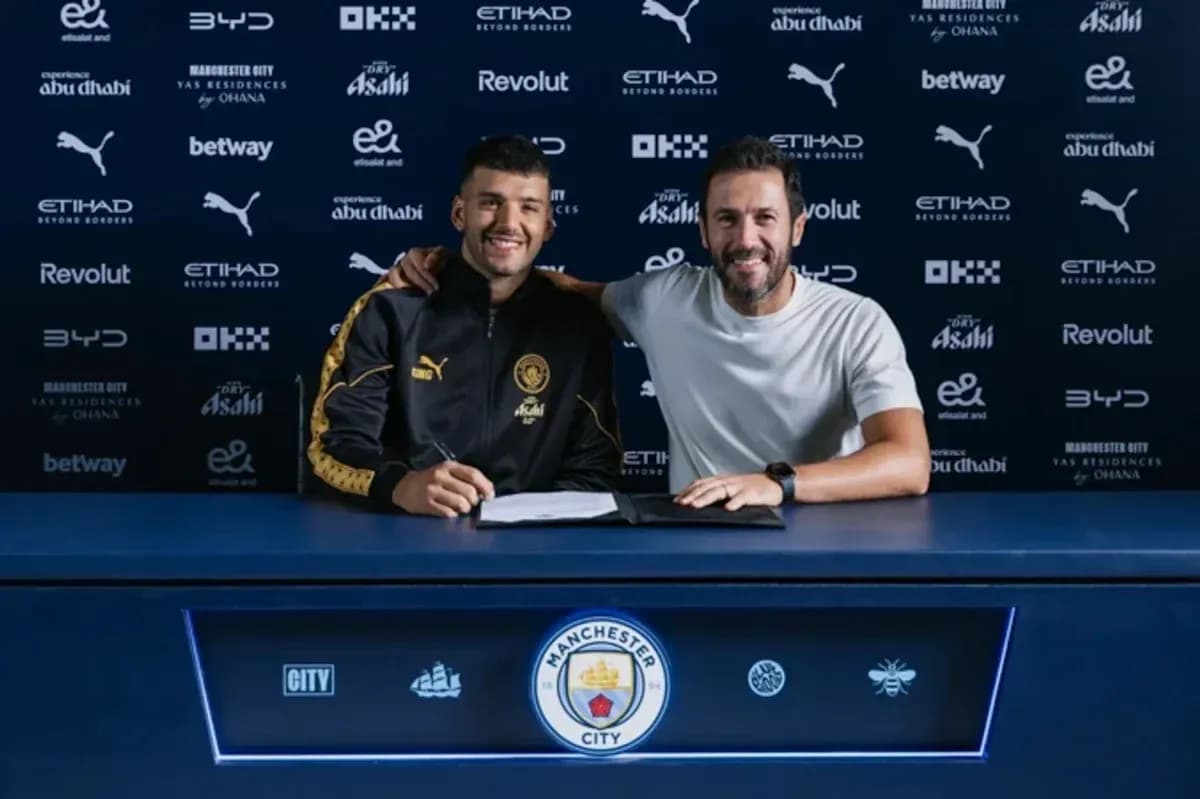 Player signing contract with club representative at table
