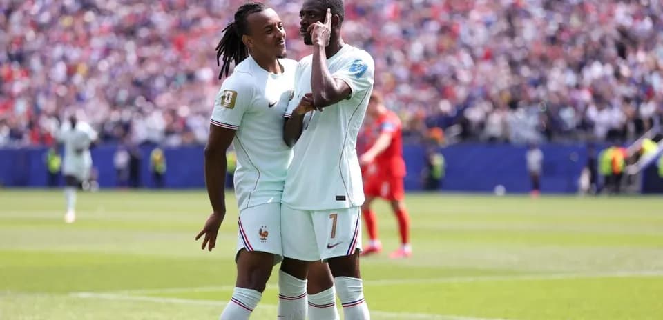 Two players celebrating a goal on the pitch