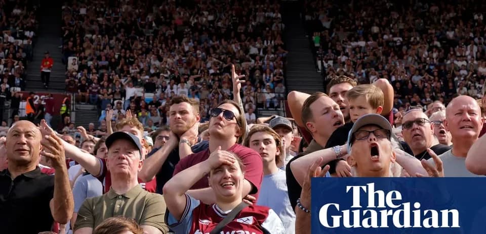 Crowd of fans reacting during a football match