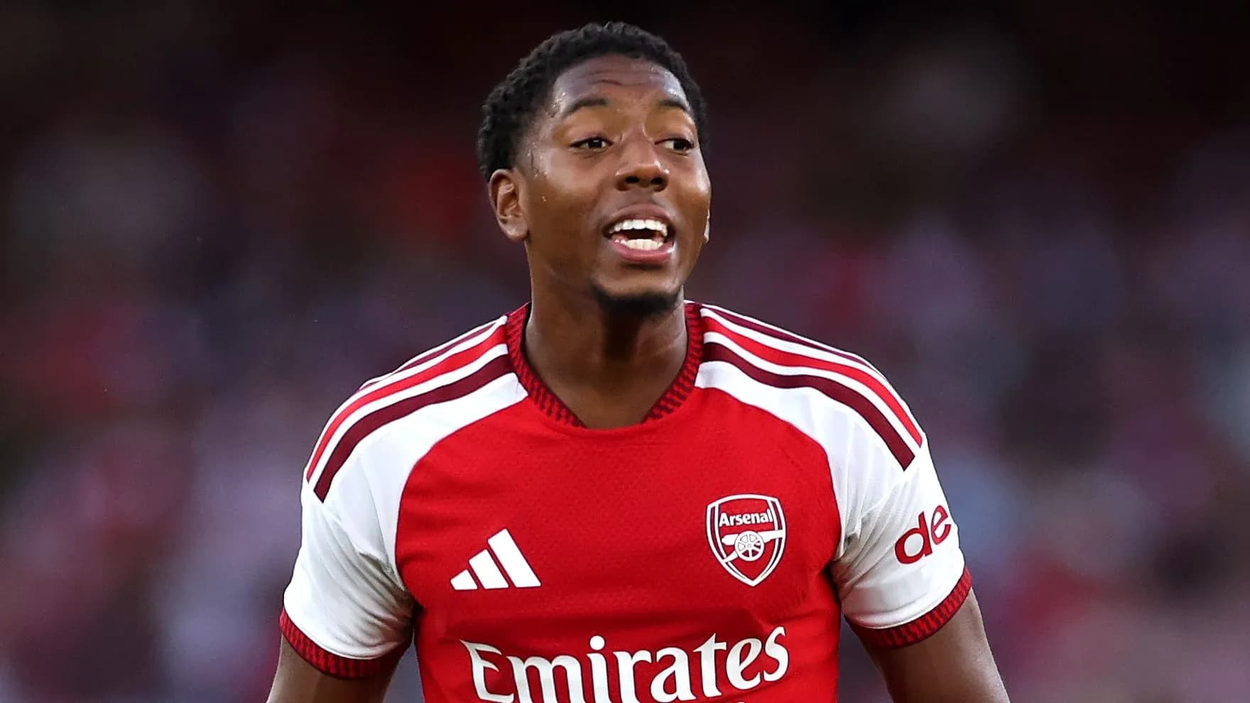 Player celebrating during a match wearing Arsenal kit