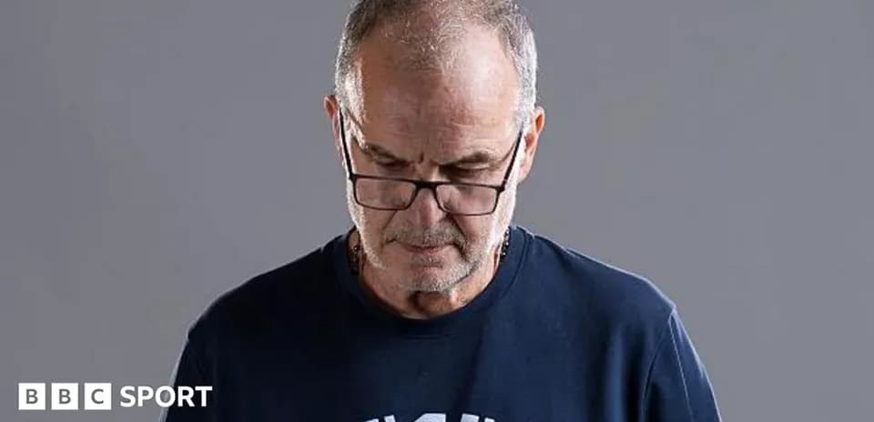 Man wearing glasses looking down thoughtfully