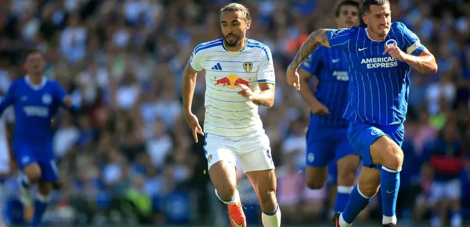 Leeds player sprinting with Brighton player in pursuit