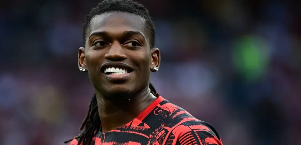 Player smiling while wearing red patterned jersey