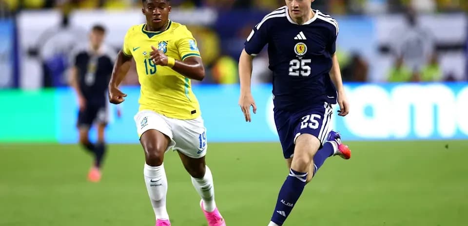 Player in blue jersey sprinting with ball, followed by opponent