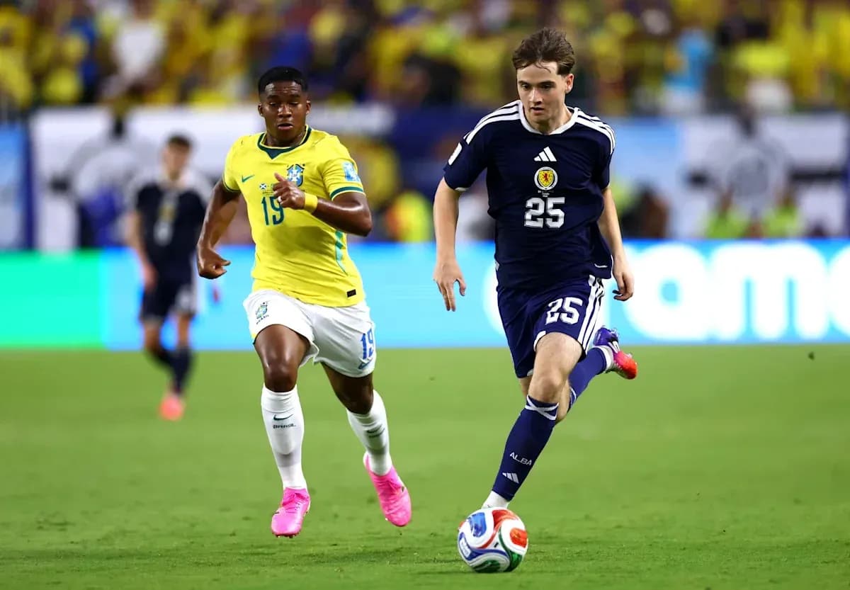 Player in blue jersey sprinting with ball, followed by opponent