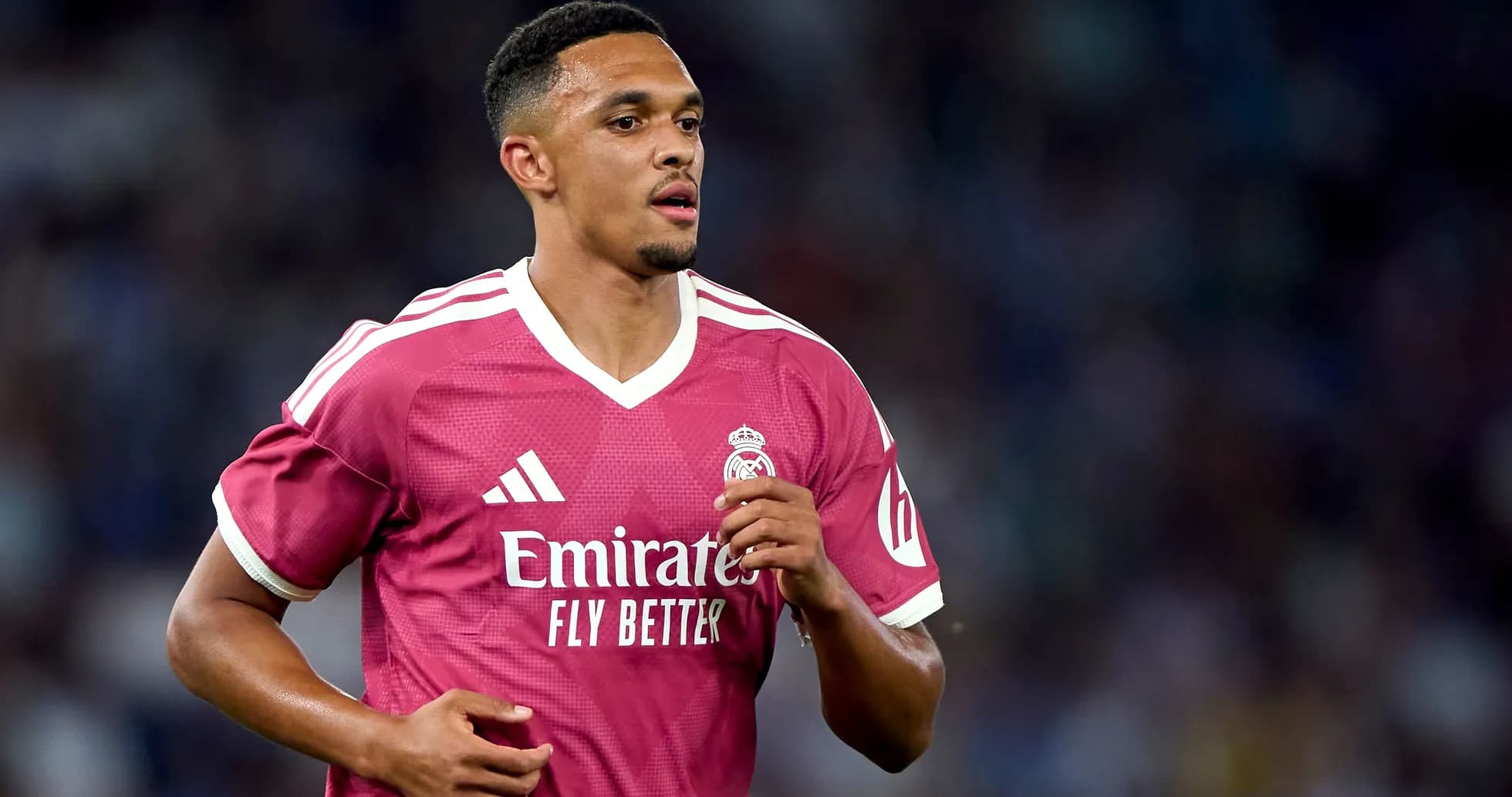 Player in pink Real Madrid jersey running on field