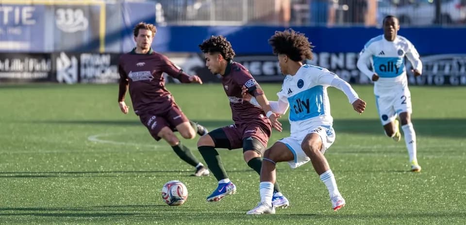 Players competing for the ball in MLS Next Pro match