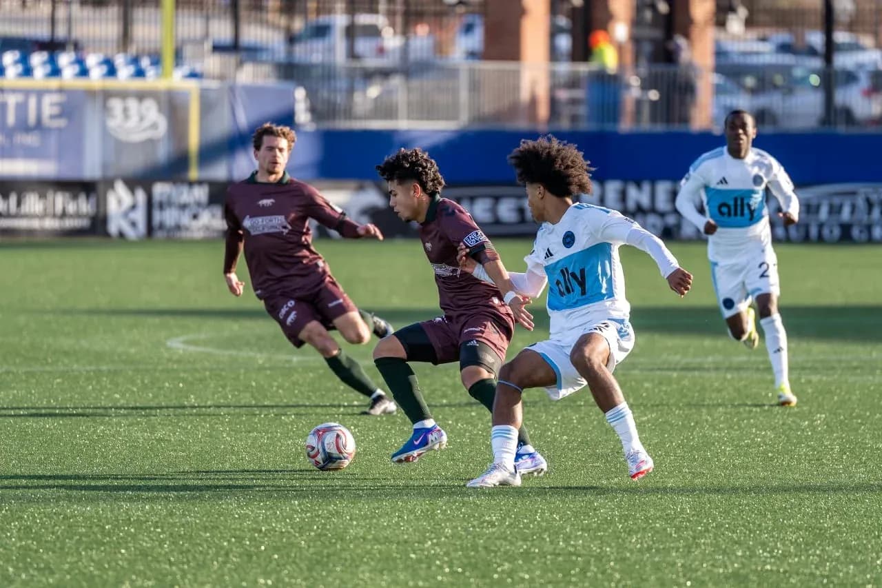 Players competing for the ball in MLS Next Pro match