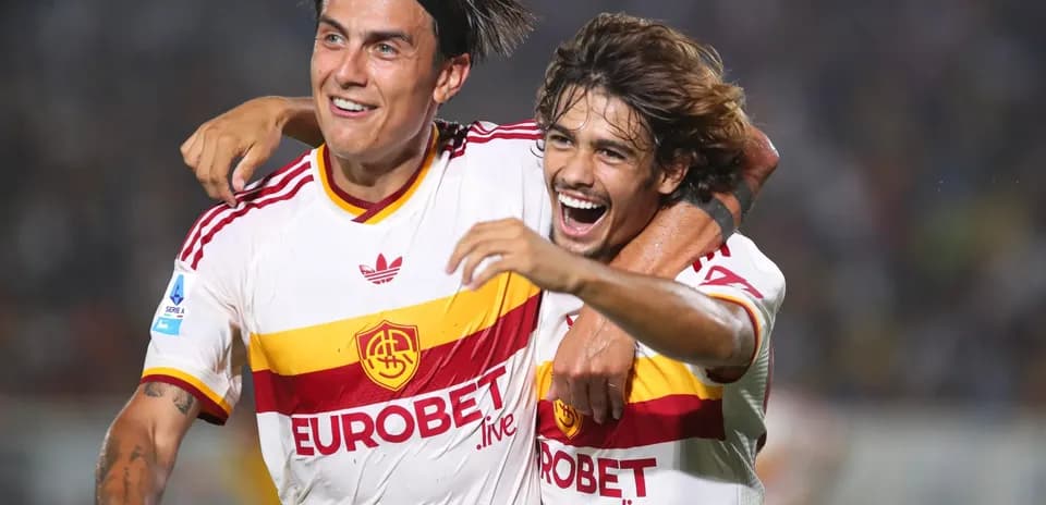 Two AS Roma players celebrating a goal