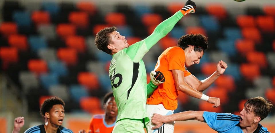 Goalkeeper punching the ball during match action
