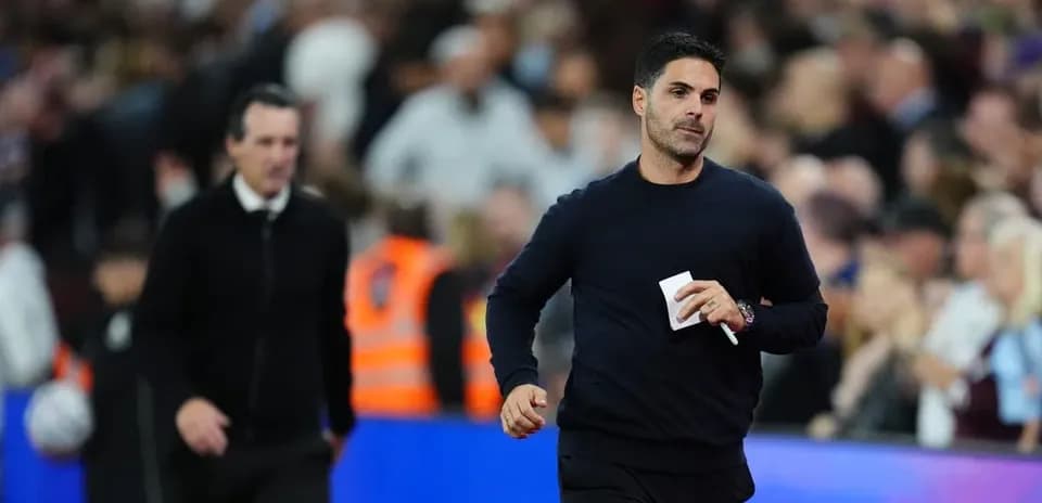 Two football managers walking on the pitch