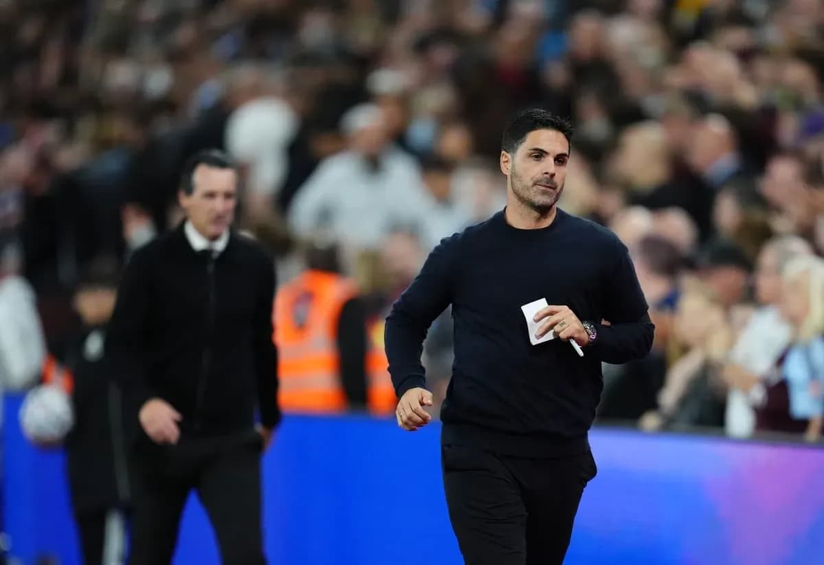 Two football managers walking on the pitch
