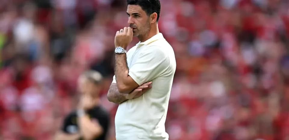 Coach observing match with hand on chin
