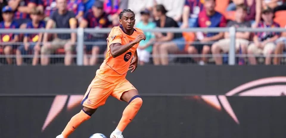 Player in orange kit running on the field