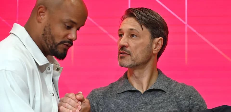Two men shaking hands during a press event