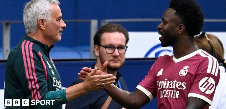 Manager and player shaking hands on field