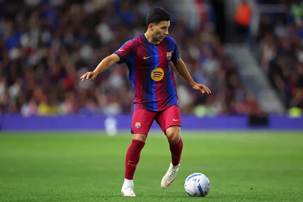 Player in Barcelona kit controlling the ball on field