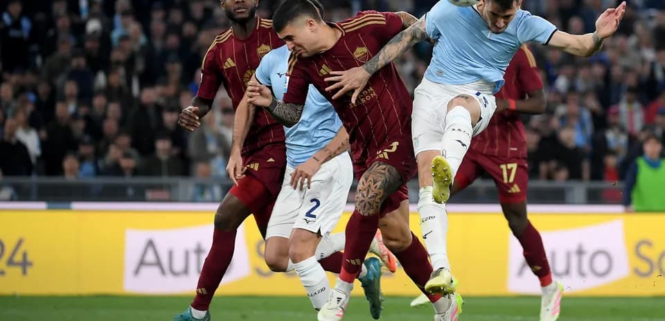 AS Roma players challenging Lazio forward during match