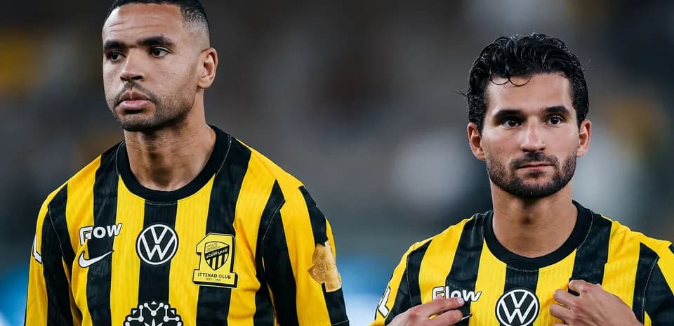 Two players in Ittihad Club jerseys on field