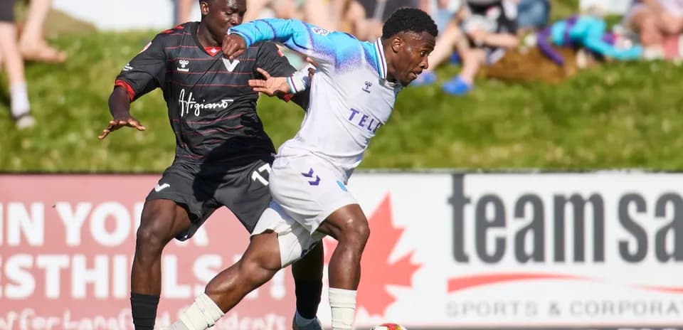 Player tackling opponent during Pacific FC match