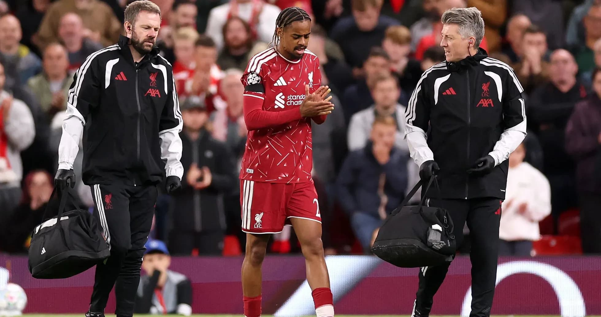 Liverpool player leaving field with medical staff